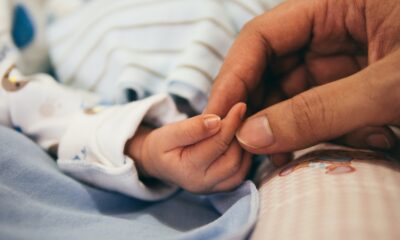 Hand holding baby's hand