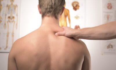 Man receives shoulder massage in a physician's clinic