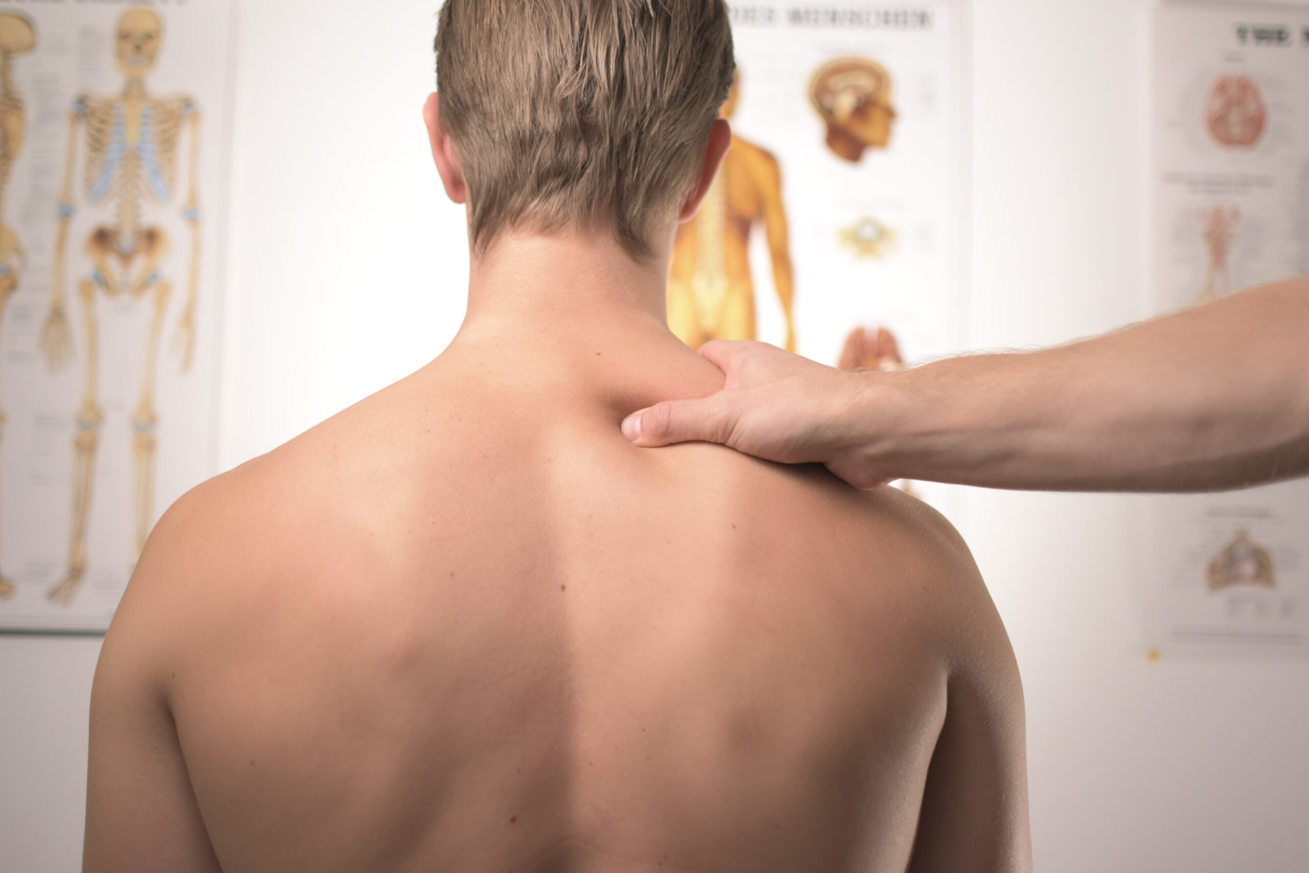 Man receives shoulder massage in a physician's clinic