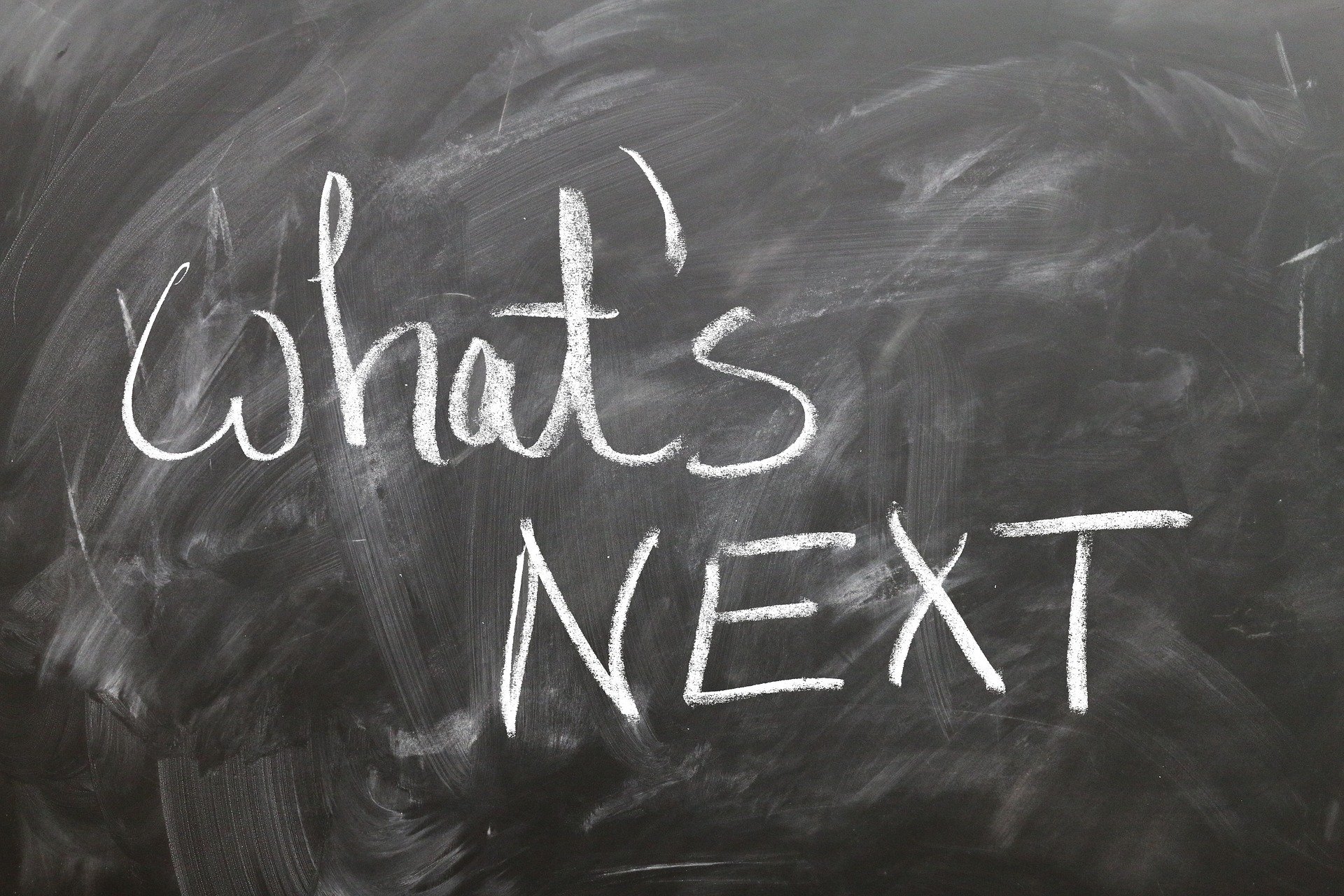 The words What's Next on a blackboard