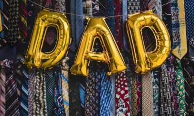Balloons spell out DAD hang over a selection of men's ties