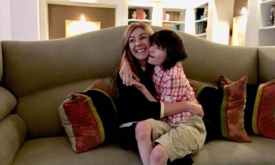 Mother and son hug on the couch at home