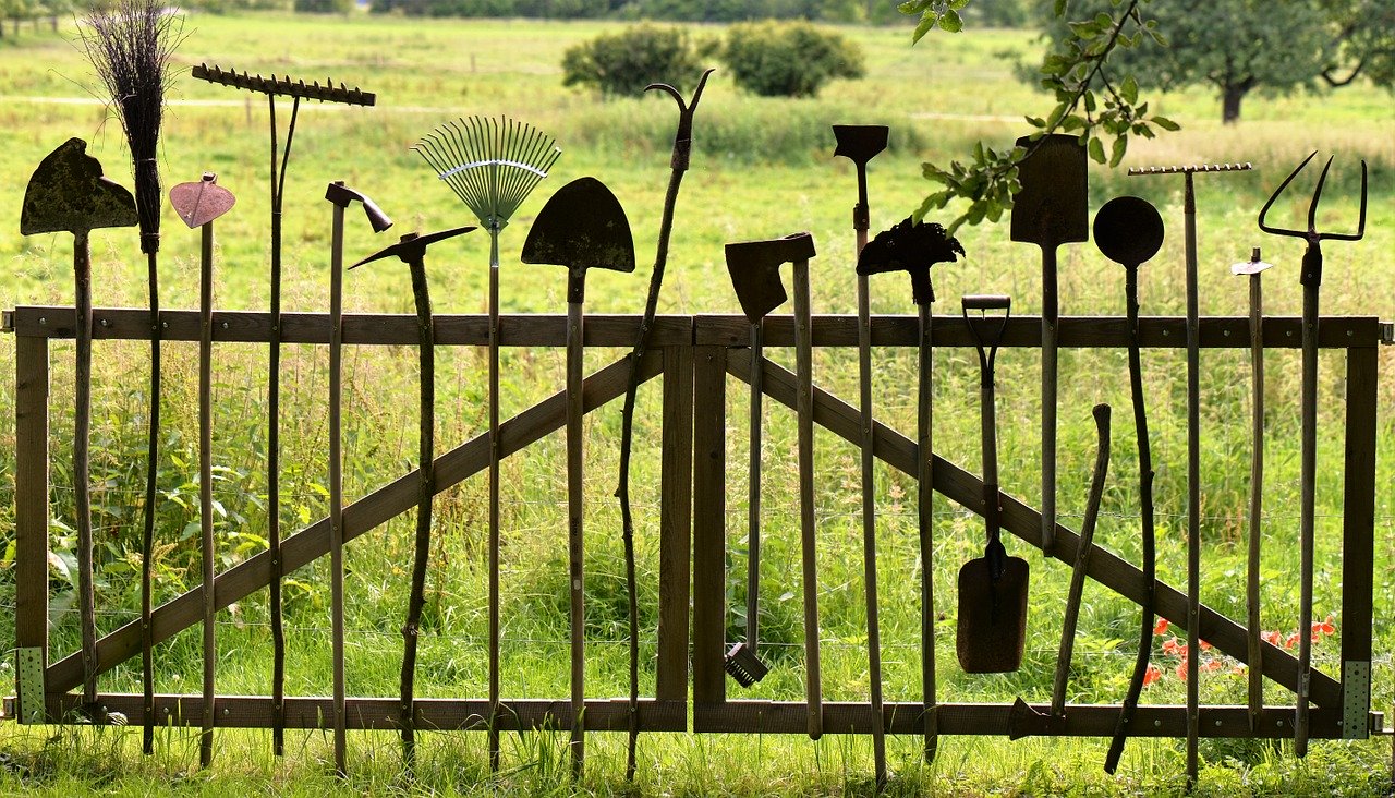 A close up of gardening tools on a fence