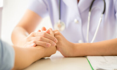 Doctor holding patient's hand