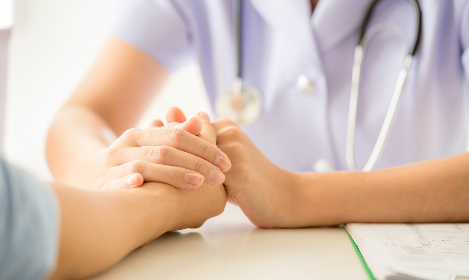 Doctor holding patient's hand