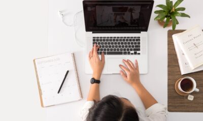 Woman with a laptop studying and making notes