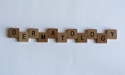 The word 'dermatology' spelled out using scrabble letters