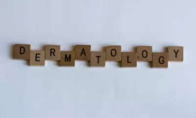The word 'dermatology' spelled out using scrabble letters