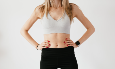 Unrecognisable woman poses in crop top and leggings