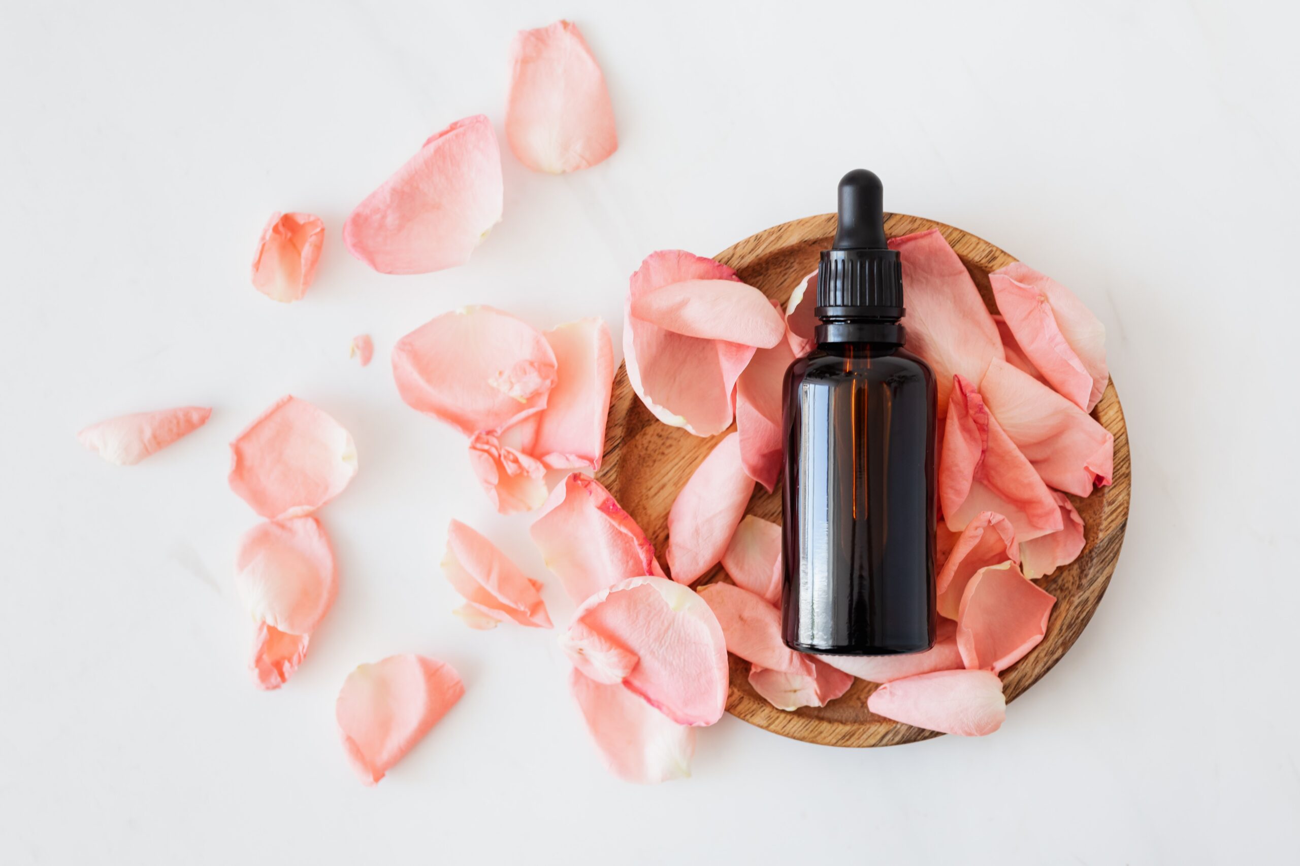 cbd oil tincture bottle on rose petals