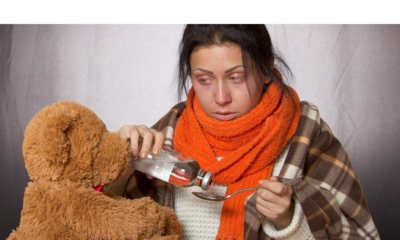 Woman taking medicine from a spoon