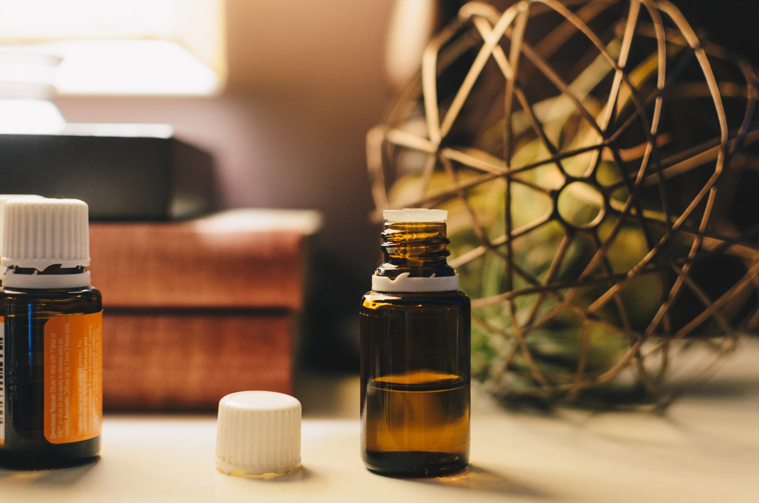 A brown bottle of oil on a wooden table