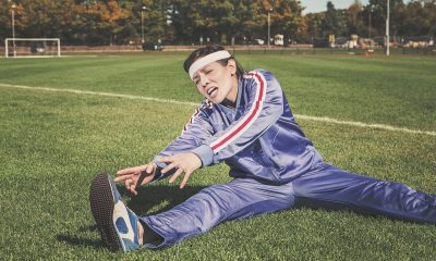 Woman in tracksuit stretching