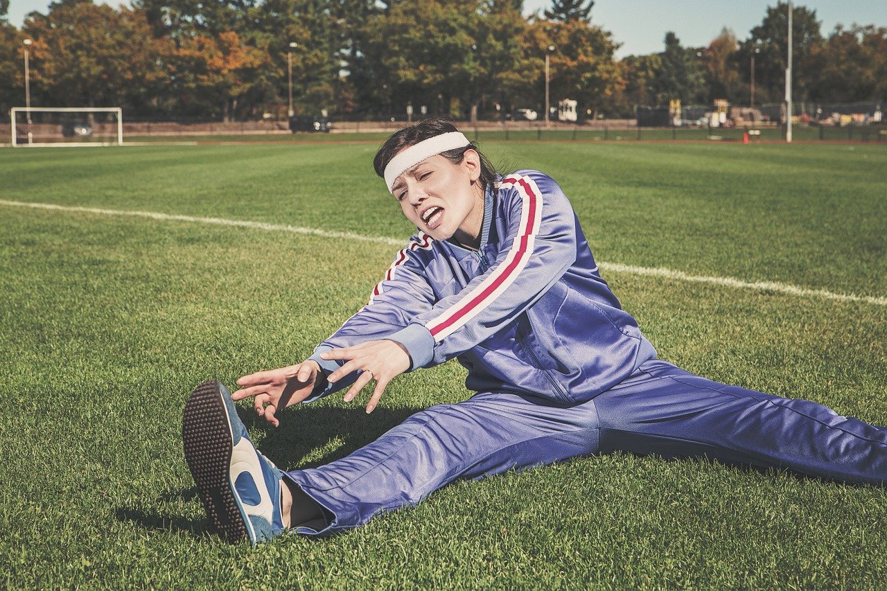 Woman in tracksuit stretching