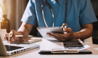 Doctor working with mobile phone and stethoscope in modern office