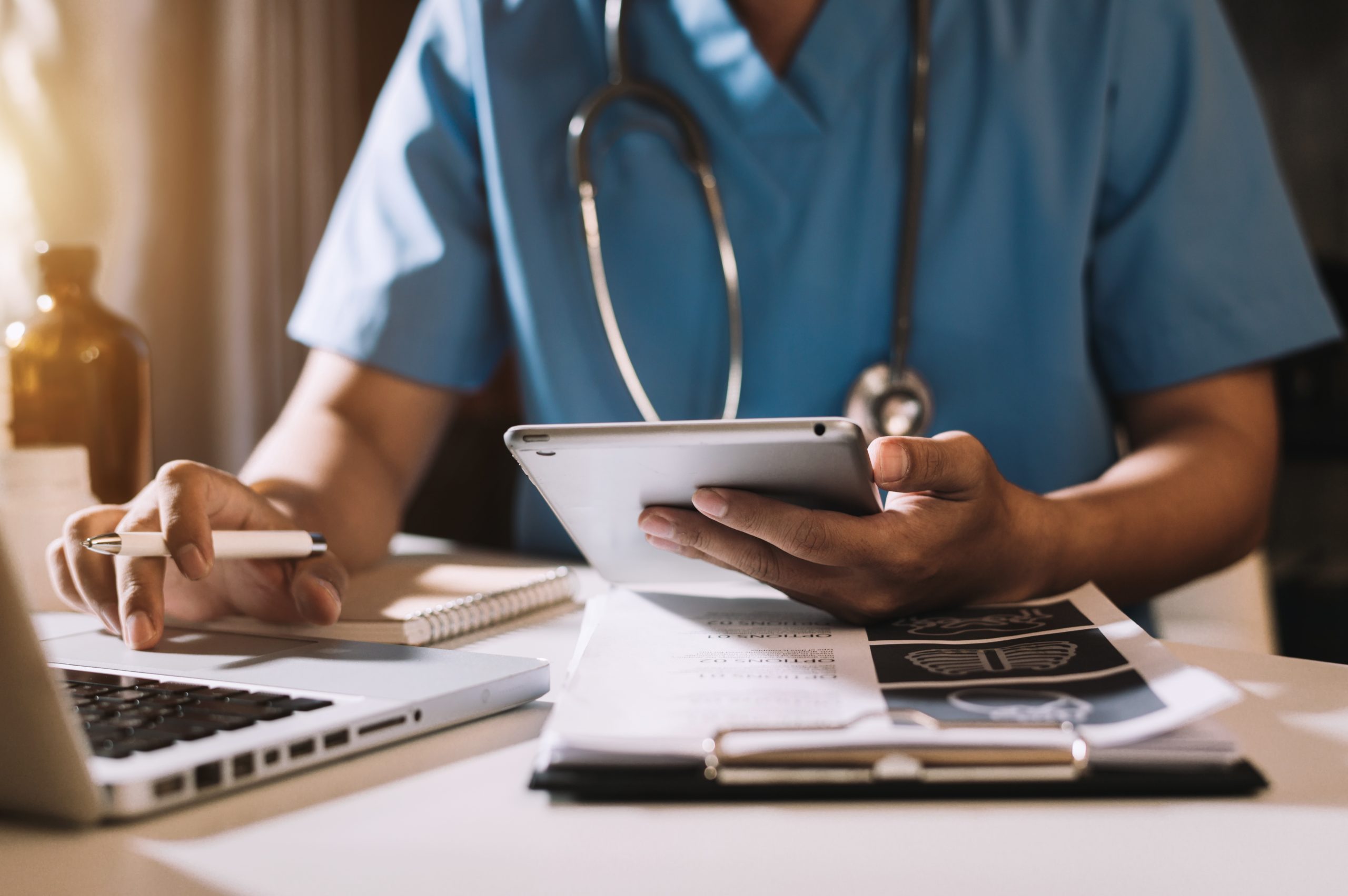 Doctor working with mobile phone and stethoscope in modern office