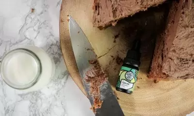 Chocolate cake with a glass of CBD and Hippie Turtle Herbal Co CBD oil.