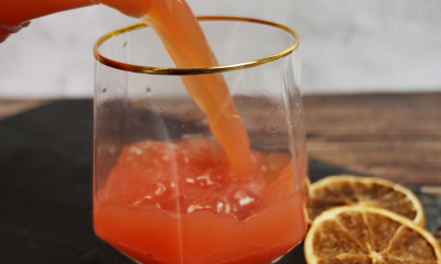 CBD-infused mocktail being poured into glass from pitcher