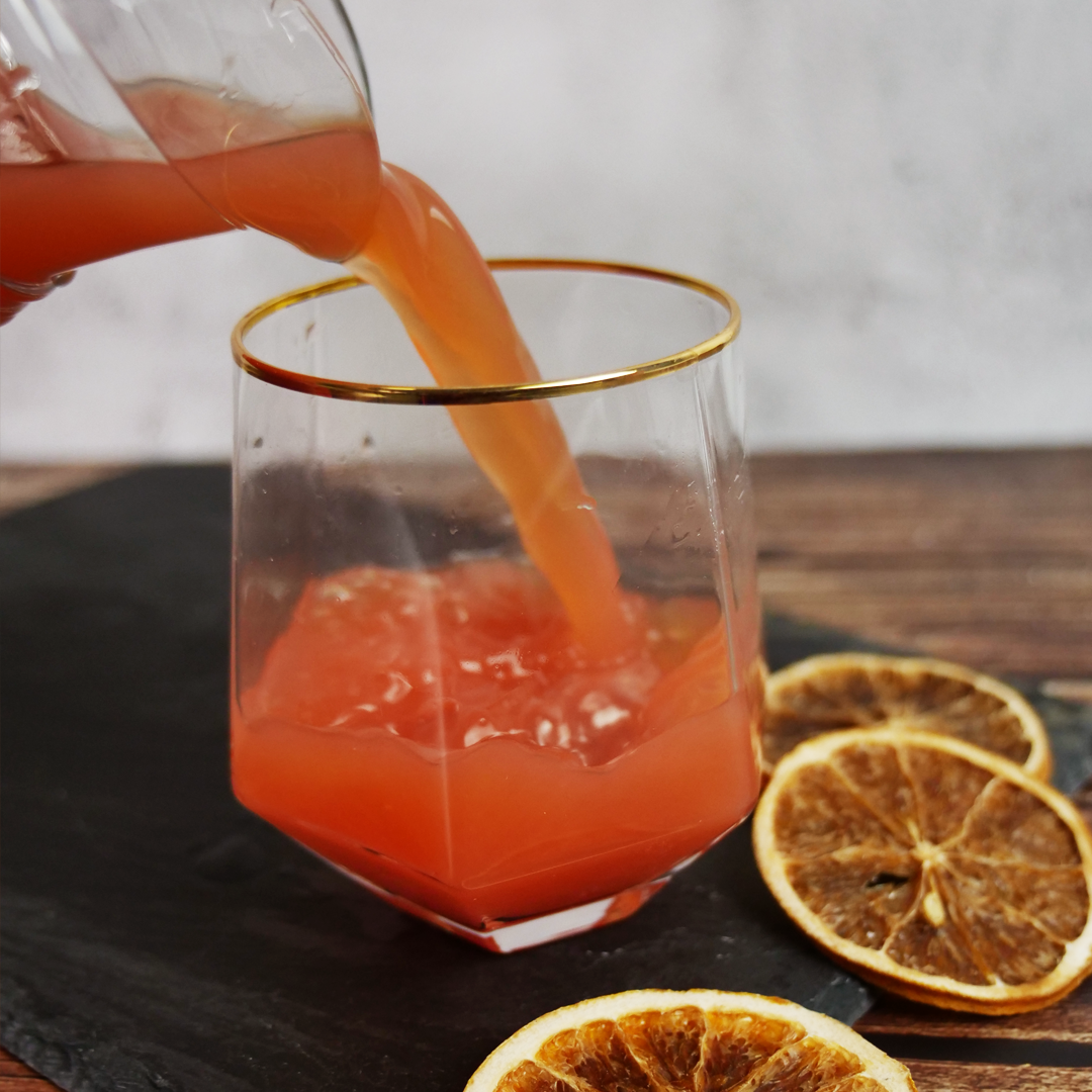 CBD-infused mocktail being poured into glass from pitcher