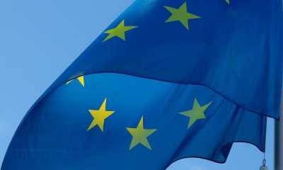 A European flag against a blue background