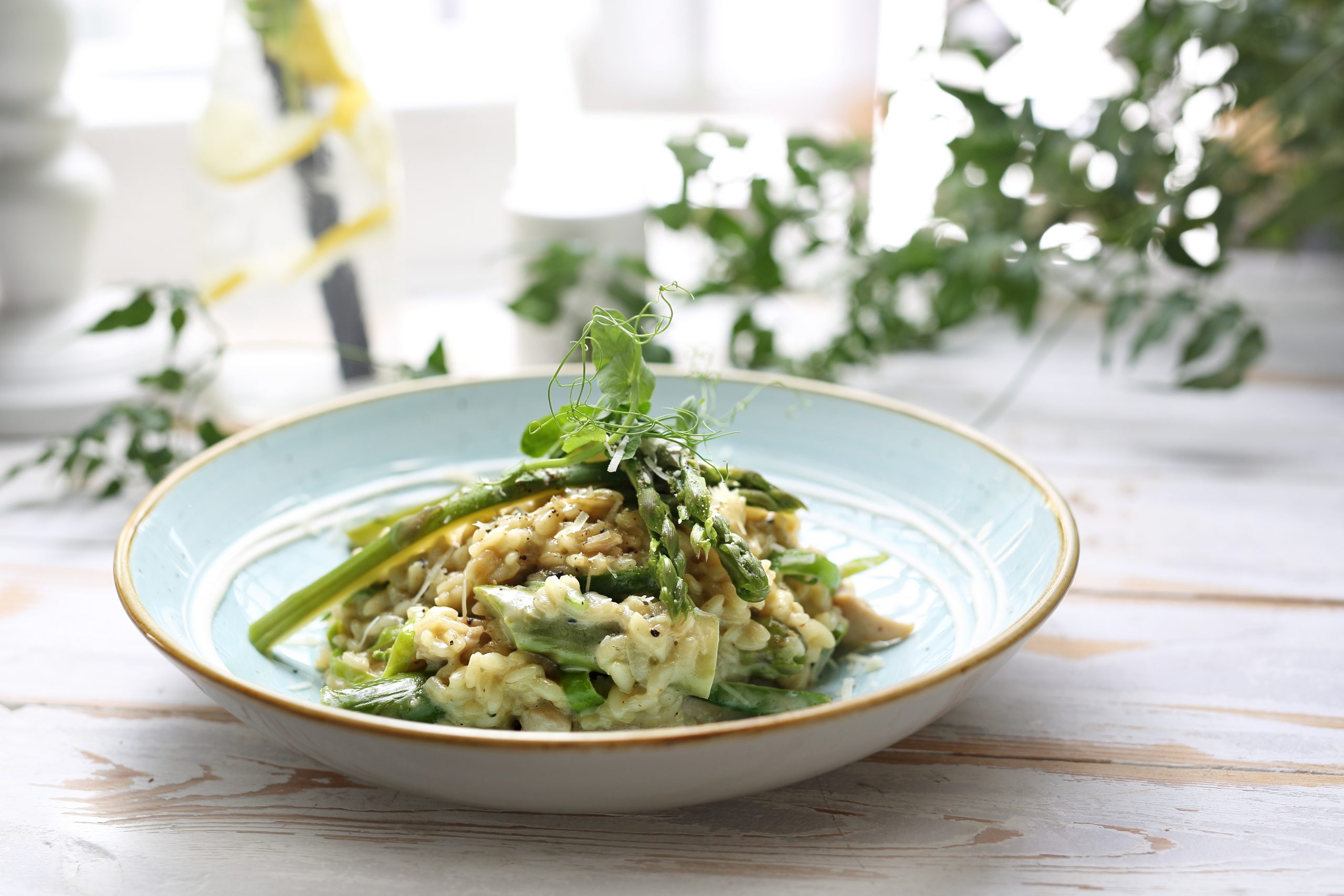 Risotto in a dish on a table. Decorated with foliage.