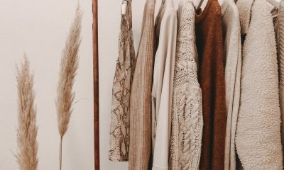 A row of hemp fashion hanging on a rail in beige and brown tones