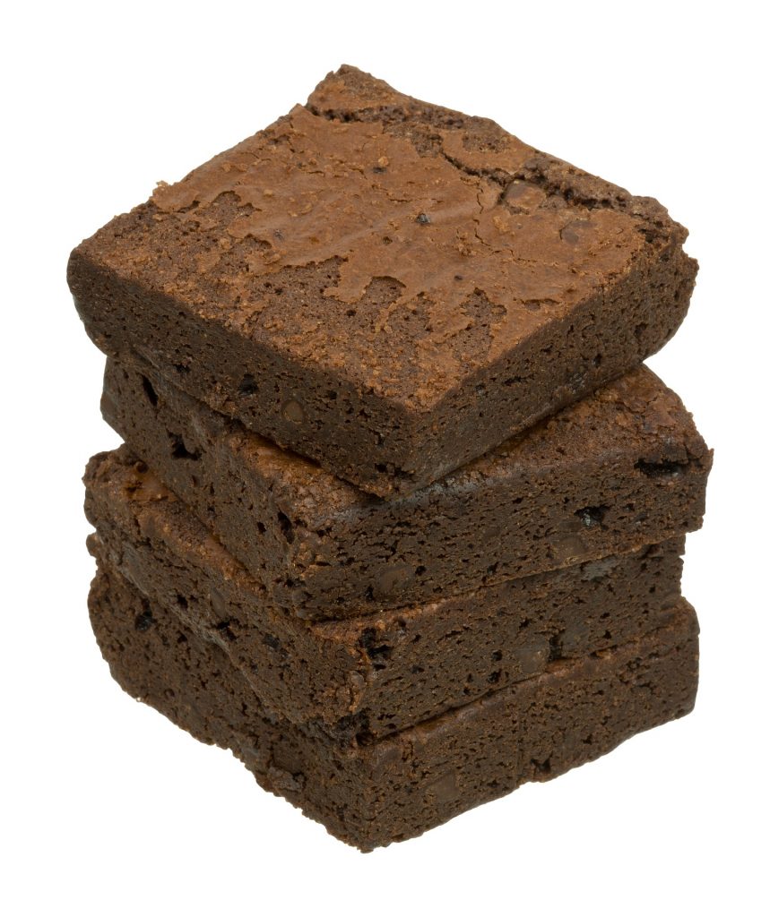 A stack of chocolate brownies on a white background. 