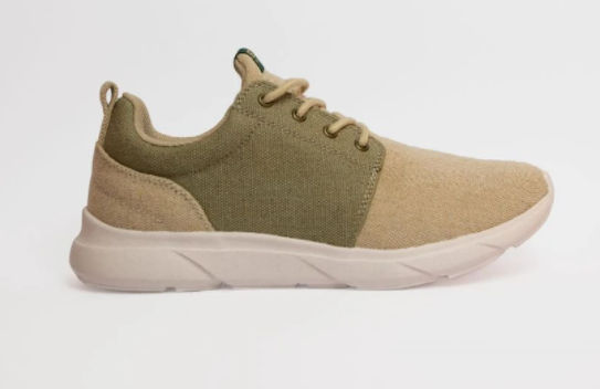 A green and beige sneaker made from hemp on a white background