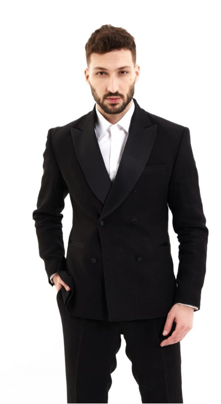 A man in a black suit made from hemp. He wears a white shirt.