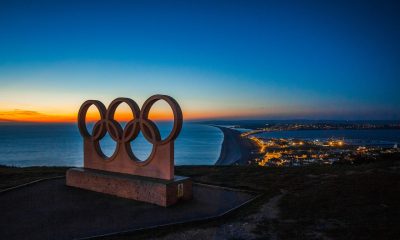 Olympic statue over water