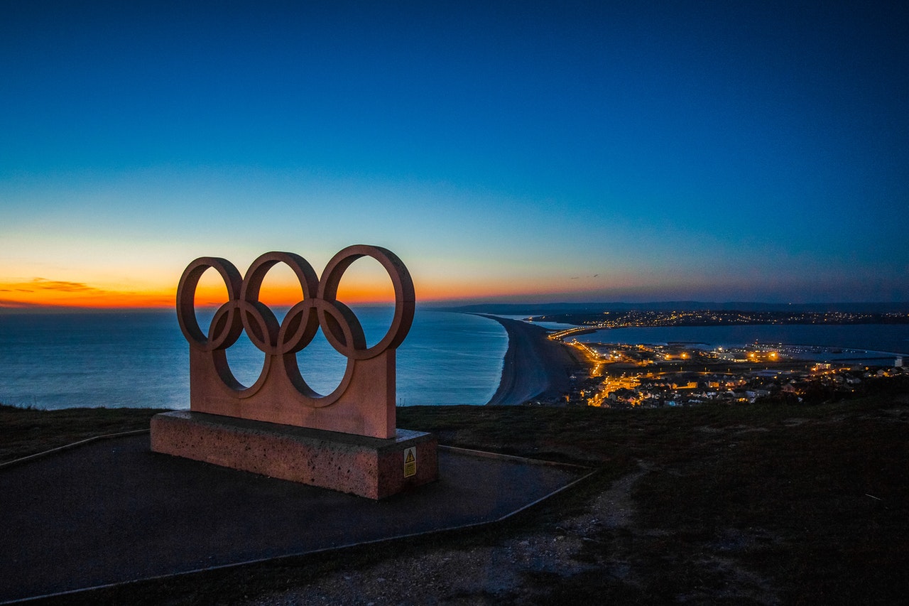 Olympic statue over water