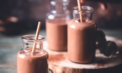 Chocolate milkshake presented in a milk bottle with a straw.