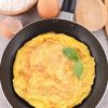 Healthy Omelette in a pan to be cut and served.