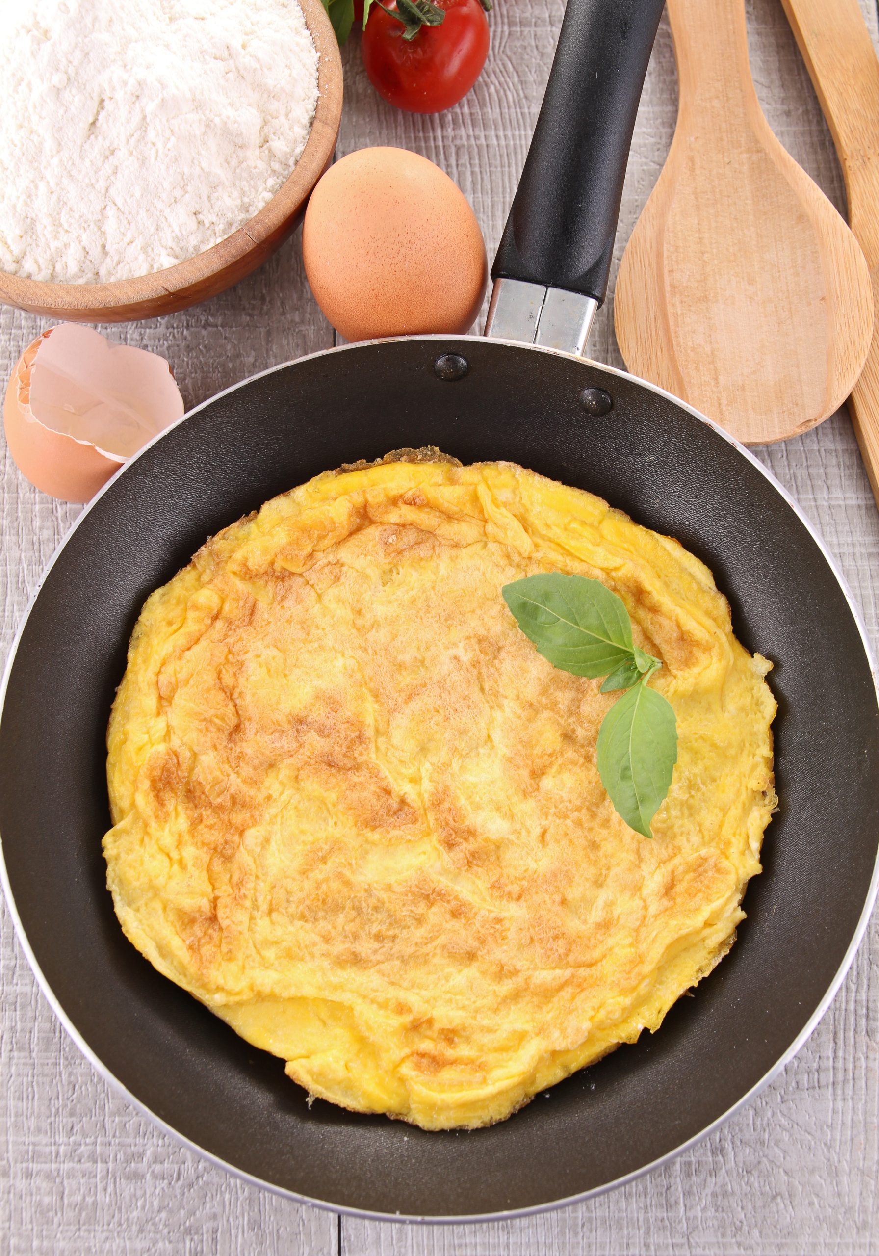 Healthy Omelette in a pan to be cut and served.