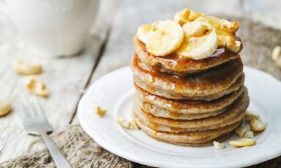 Banana pancakes topped with a sweet sauce and clices of banana, perfect for pancake day.