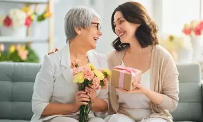 Mother and daughter exchanging gifts for Mother's Day.