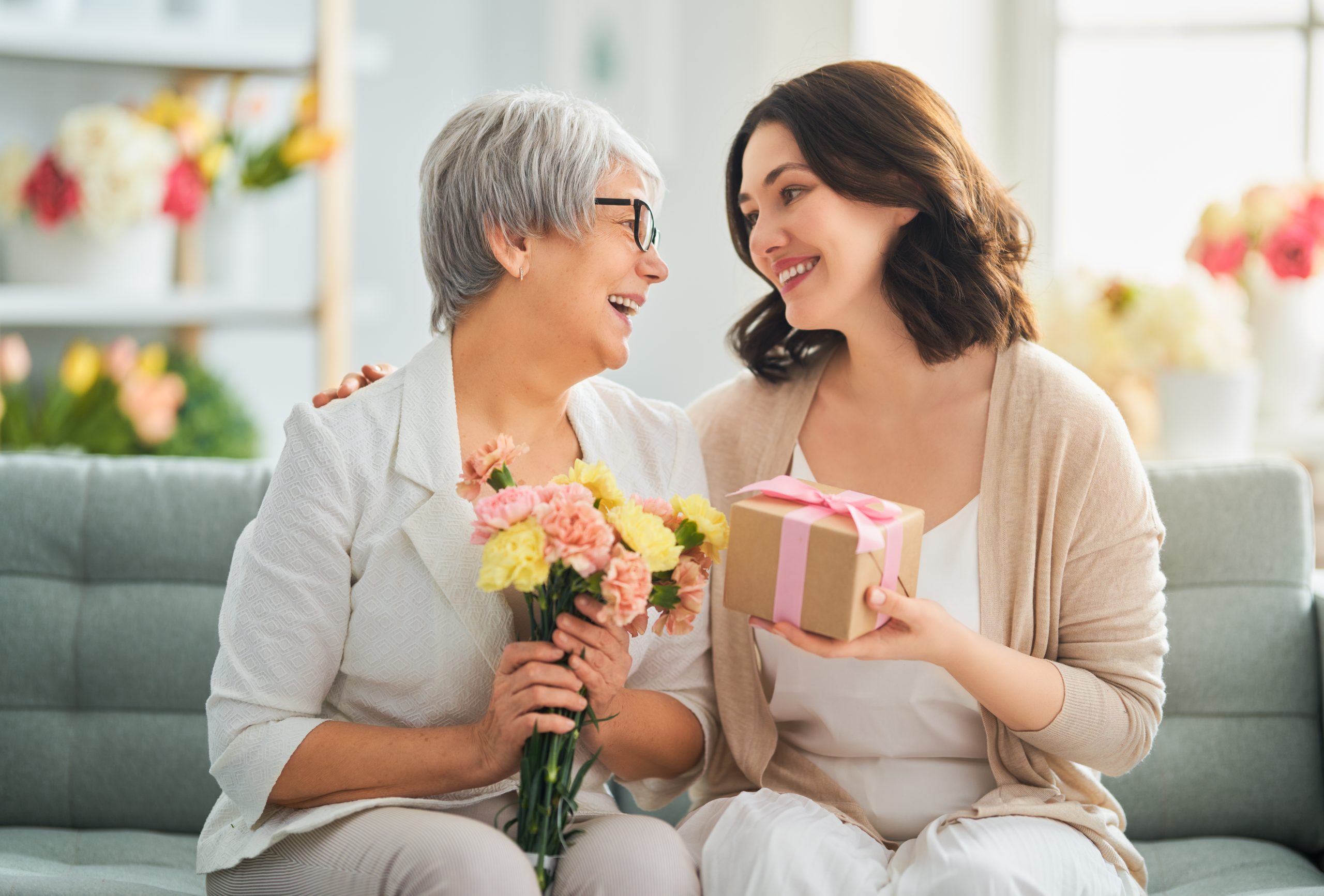 Mother and daughter exchanging gifts for Mother's Day.