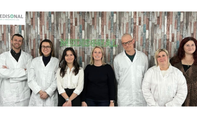 Medisonal team infront of their office wall.