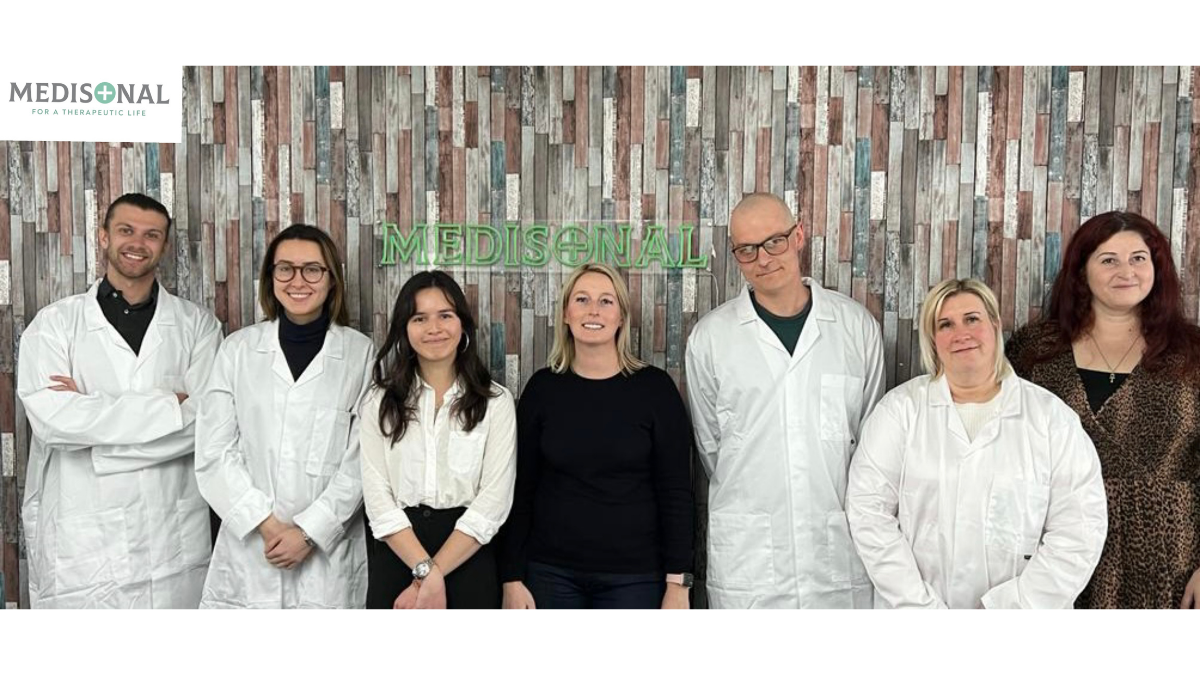 Medisonal team infront of their office wall.