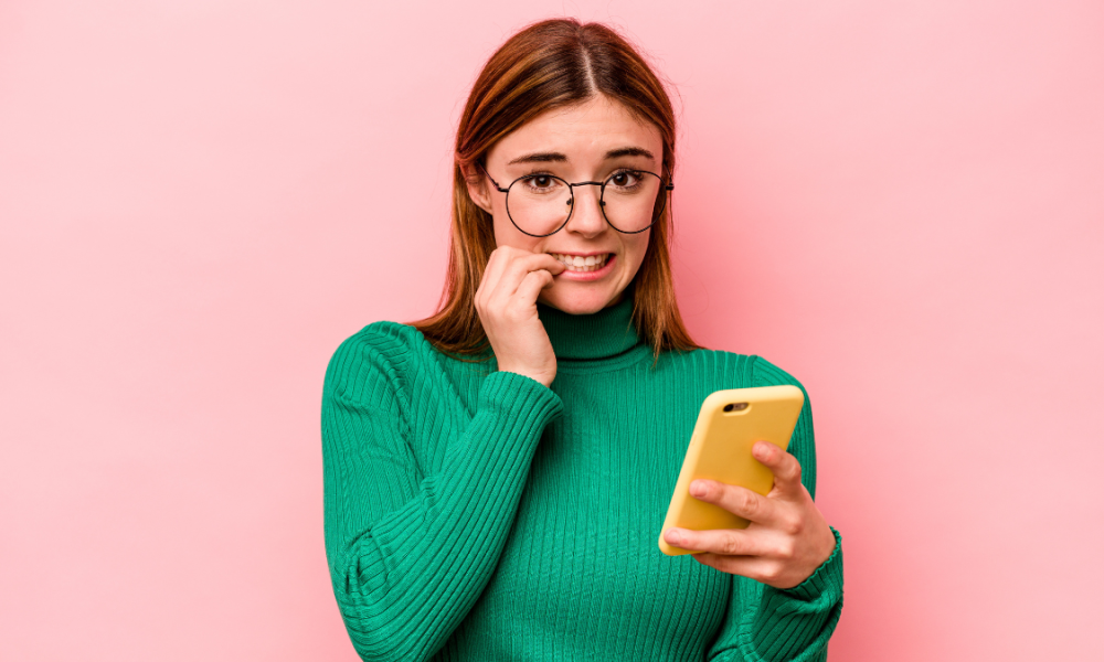 A young lady suffering with phone anxiety.